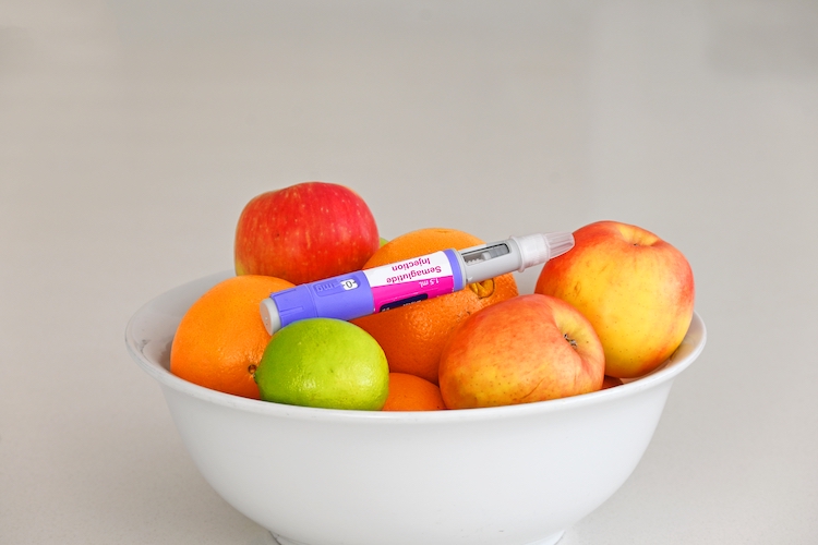 Semaglutide injection pen in a bowl of fruit