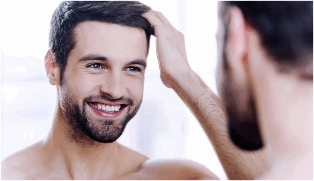 Happy man looking in the mirror after Hair Loss Treatment Happy man looking in the mirror after Hair Loss Treatment